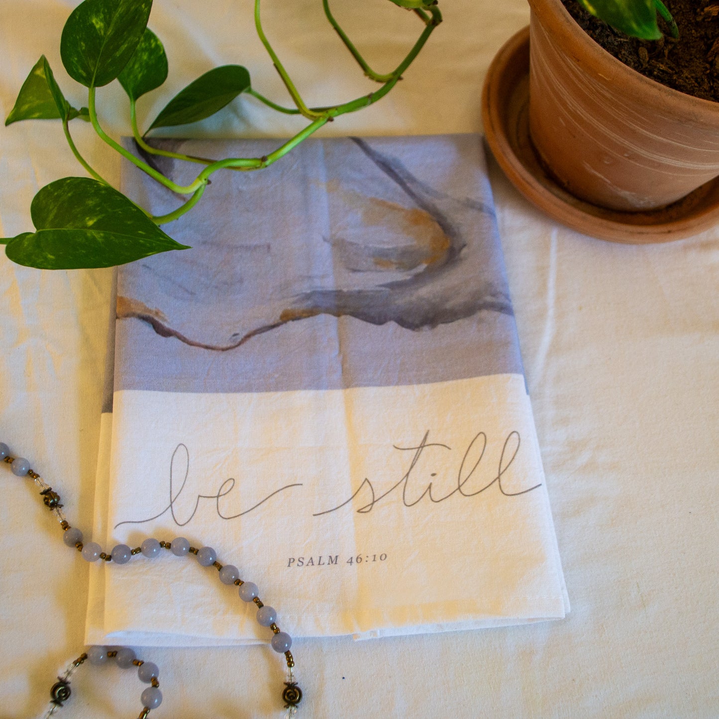 Oyster painting with psalm 46:10 "Be Still" on a tea towel